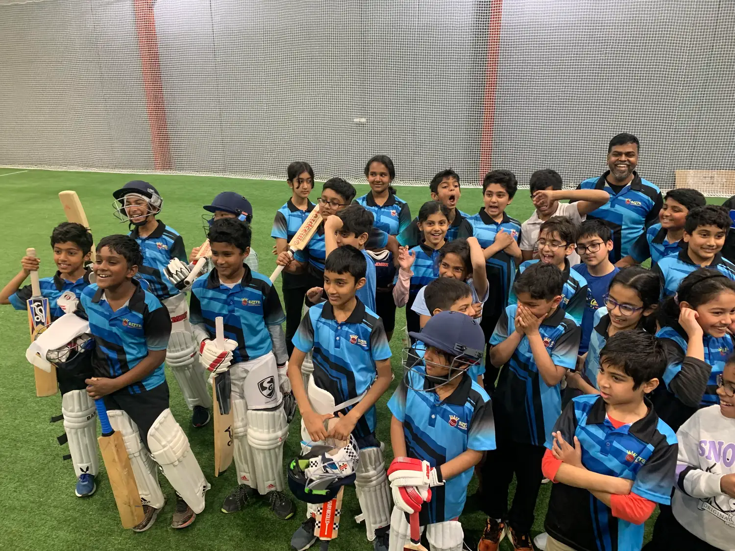 A large group of junior Elite players with their kit